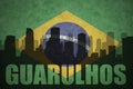 Abstract silhouette of the city with text Guarulhos at the vintage brazilian flag