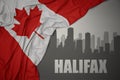 Abstract silhouette of the city with text Halifax near waving national flag of canada on a gray background Royalty Free Stock Photo