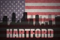 Abstract silhouette of the city with text Hartford at the vintage american flag
