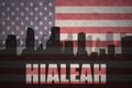 Abstract silhouette of the city with text Hialeah at the vintage american flag