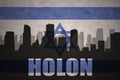 Abstract silhouette of the city with text Holon at the vintage israel flag