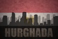 Abstract silhouette of the city with text Hurghada at the vintage egyptian flag