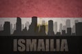 Abstract silhouette of the city with text Ismailia at the vintage egyptian flag