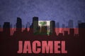 Abstract silhouette of the city with text Jacmel at the vintage haitian flag