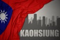 Abstract silhouette of the city with text Kaohsiung near waving national flag of taiwan on a gray background.3D illustration