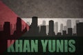 Abstract silhouette of the city with text Khan Yunis at the vintage palestinian flag Royalty Free Stock Photo