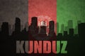 Abstract silhouette of the city with text Kunduz at the vintage afghanistan flag