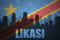 Abstract silhouette of the city with text Likasi at the vintage democratic republic of the congo flag