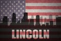 Abstract silhouette of the city with text Lincoln at the vintage american flag Royalty Free Stock Photo