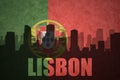 Abstract silhouette of the city with text Lisbon at the vintage portuguese flag
