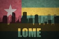 Abstract silhouette of the city with text Lome at the vintage togo flag