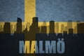 Abstract silhouette of the city with text Malmo at the vintage swedish flag