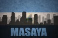 Abstract silhouette of the city with text Masaya at the vintage nicaraguan flag