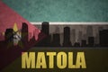 Abstract silhouette of the city with text Matola at the vintage mozambican flag