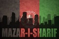 Abstract silhouette of the city with text Mazar-i-Sharif at the vintage afghanistan flag