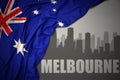 Abstract silhouette of the city with text Melbourne near waving national flag of australia on a gray background