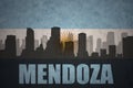 Abstract silhouette of the city with text Mendoza at the vintage argentinean flag