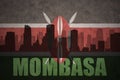 Abstract silhouette of the city with text Mombasa at the vintage kenyan flag Royalty Free Stock Photo