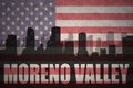 Abstract silhouette of the city with text Moreno Valley at the vintage american flag