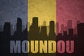 Abstract silhouette of the city with text Moundou at the vintage chad flag