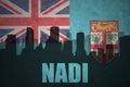 Abstract silhouette of the city with text Nadi at the vintage Fiji flag