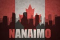 Abstract silhouette of the city with text Nanaimo at the vintage canadian flag