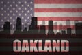 Abstract silhouette of the city with text Oakland at the vintage american flag