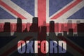 Abstract silhouette of the city with text Oxford at the vintage british flag