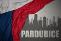 Abstract silhouette of the city with text Pardubice near waving national flag of czech republic on a gray background Royalty Free Stock Photo