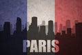 Abstract silhouette of the city with text Paris at the vintage french flag Royalty Free Stock Photo