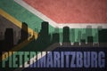 Abstract silhouette of the city with text Pietermaritzburg at the vintage south africa flag