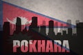 abstract silhouette of the city with text Pokhara at the vintage nepal flag