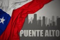 Abstract silhouette of the city with text Puente Alto near waving national flag of chile on a gray background