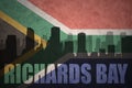 Abstract silhouette of the city with text Richards Bay at the vintage south africa flag