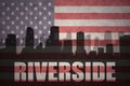 Abstract silhouette of the city with text Riverside at the vintage american flag