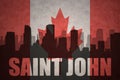 Abstract silhouette of the city with text Saint John at the vintage canadian flag