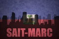 Abstract silhouette of the city with text Saint-Marc at the vintage haitian flag