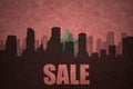 Abstract silhouette of the city with text Sale at the vintage moroccan flag
