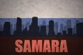 Abstract silhouette of the city with text Samara at the vintage russian flag