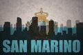 Abstract silhouette of the city with text san marino at the vintage san marino flag