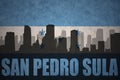Abstract silhouette of the city with text San Pedro Sula at the vintage honduras flag