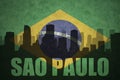 Abstract silhouette of the city with text Sao Paulo at the vintage brazilian flag