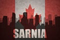 Abstract silhouette of the city with text Sarnia at the vintage canadian flag