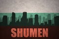 Abstract silhouette of the city with text Shumen at the vintage bulgarian flag