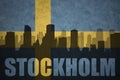 Abstract silhouette of the city with text Stockholm at the vintage swedish flag