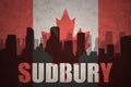 Abstract silhouette of the city with text Sudbury at the vintage canadian flag