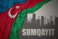 Abstract silhouette of the city with text Sumgait near waving national flag of azerbaijan on a gray background