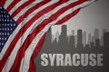 Abstract silhouette of the city with text Syracuse near waving colorful national flag of united states of america on a gray Royalty Free Stock Photo