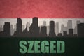 Abstract silhouette of the city with text Szeged at the vintage hungarian flag