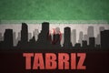 Abstract silhouette of the city with text Tabriz at the vintage iranian flag